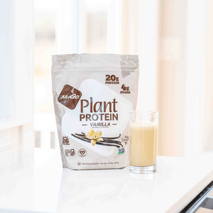 NuGo Plant Protein Vanilla package with a glass of vanilla protein shake